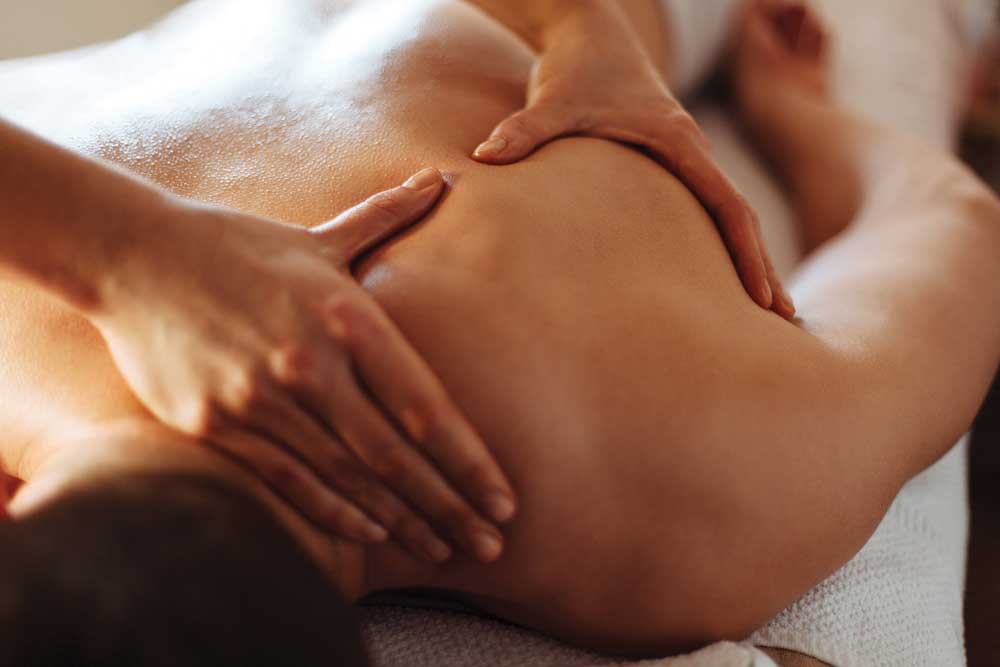 Therapists hands massaging patients shoulder